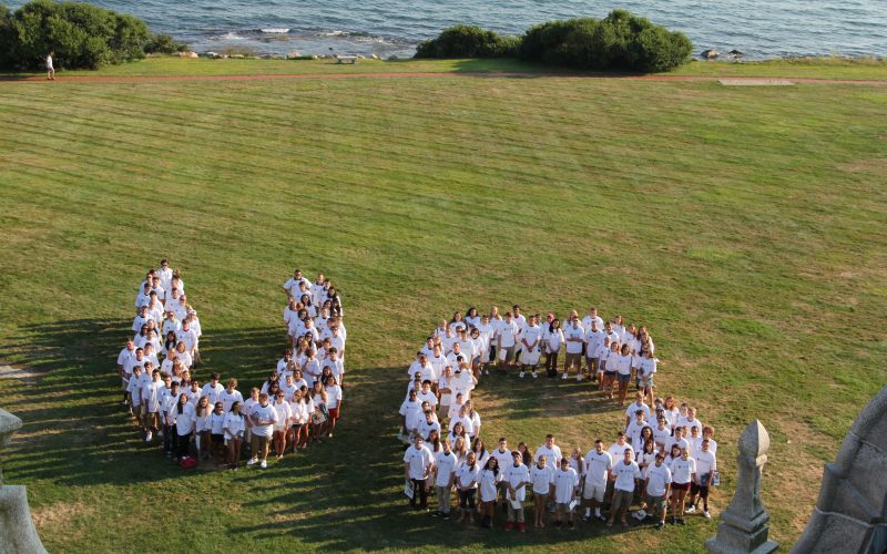 Aerial of students forming the letters "U" and "C"